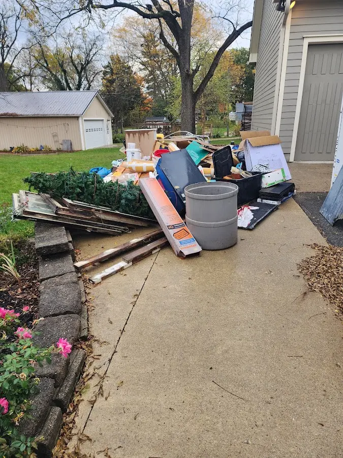 Dumpster being loaded with debris for 12 Yard Dumpster Rental in Taylor Creek